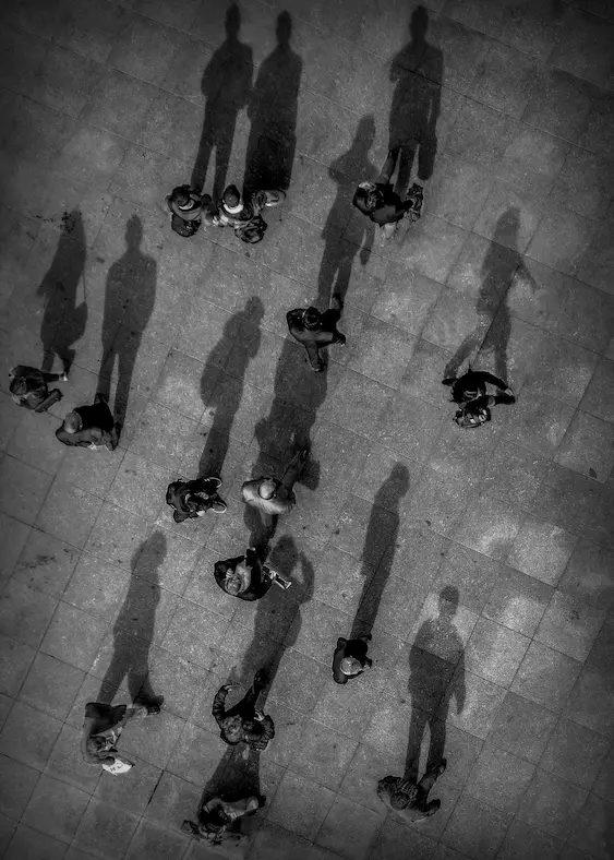 Pedestrians walking with long shadows, representing people seeking criminal law advice