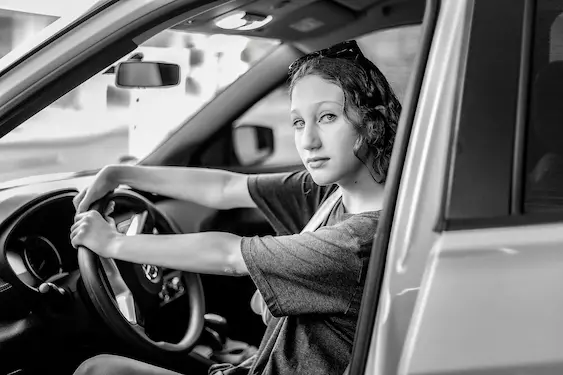 Driver behind the wheel considering her options after a traffic charge in Parramatta